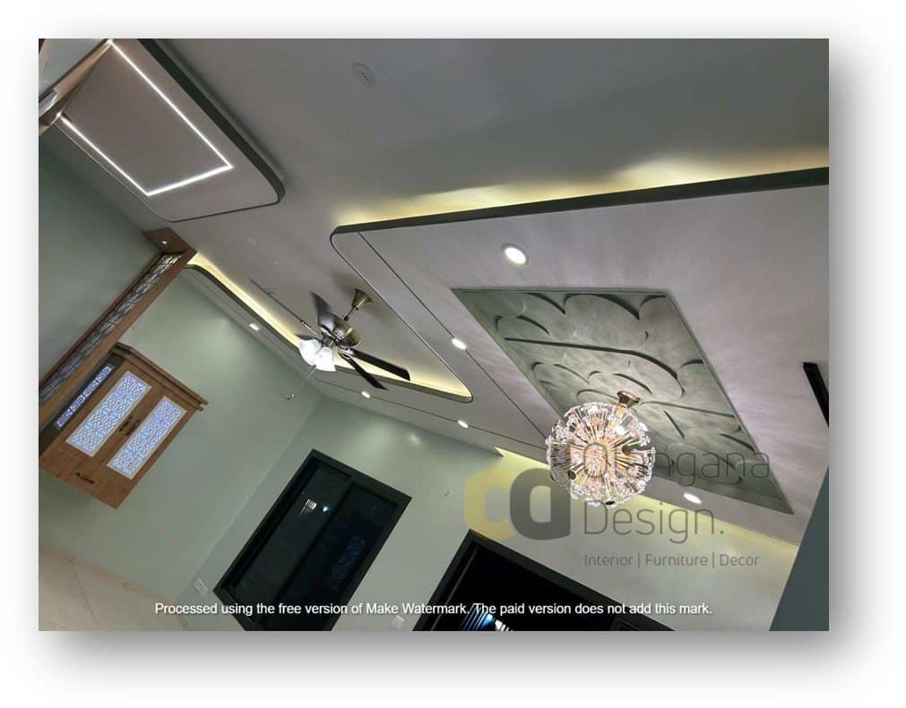 Modern false ceiling design featuring integrated LED cove lighting, recessed spotlights, an elegant crystal chandelier, and a stylish ceiling fan, expertly crafted by Olangana Design for a luxurious interior in Bangalore.