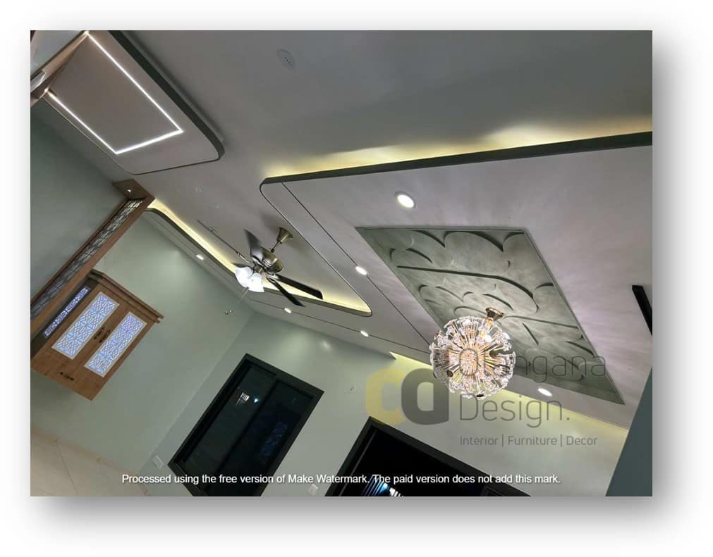 Modern false ceiling design featuring integrated LED cove lighting, recessed spotlights, an elegant crystal chandelier, and a stylish ceiling fan, expertly crafted by Olangana Design for a luxurious interior in Bangalore.