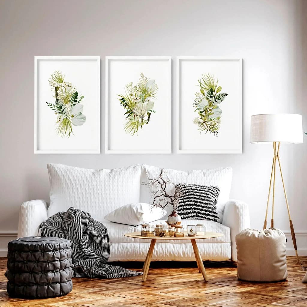 White theme living room interior designed by Olangana Designs for a Bangalore home featuring elegant wall art, comfortable sofa, and a small tea table.