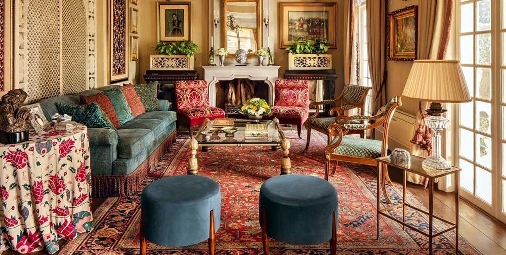 Stylish living room interior with cozy sectional sofa, wooden coffee table, and natural indoor greenery by Olangana Design’s.