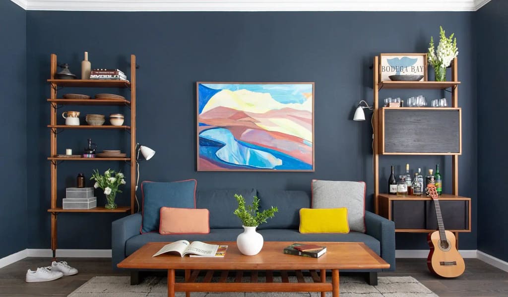 Blue sofa living room with wooden shelves, coffee table, and modern wall painting