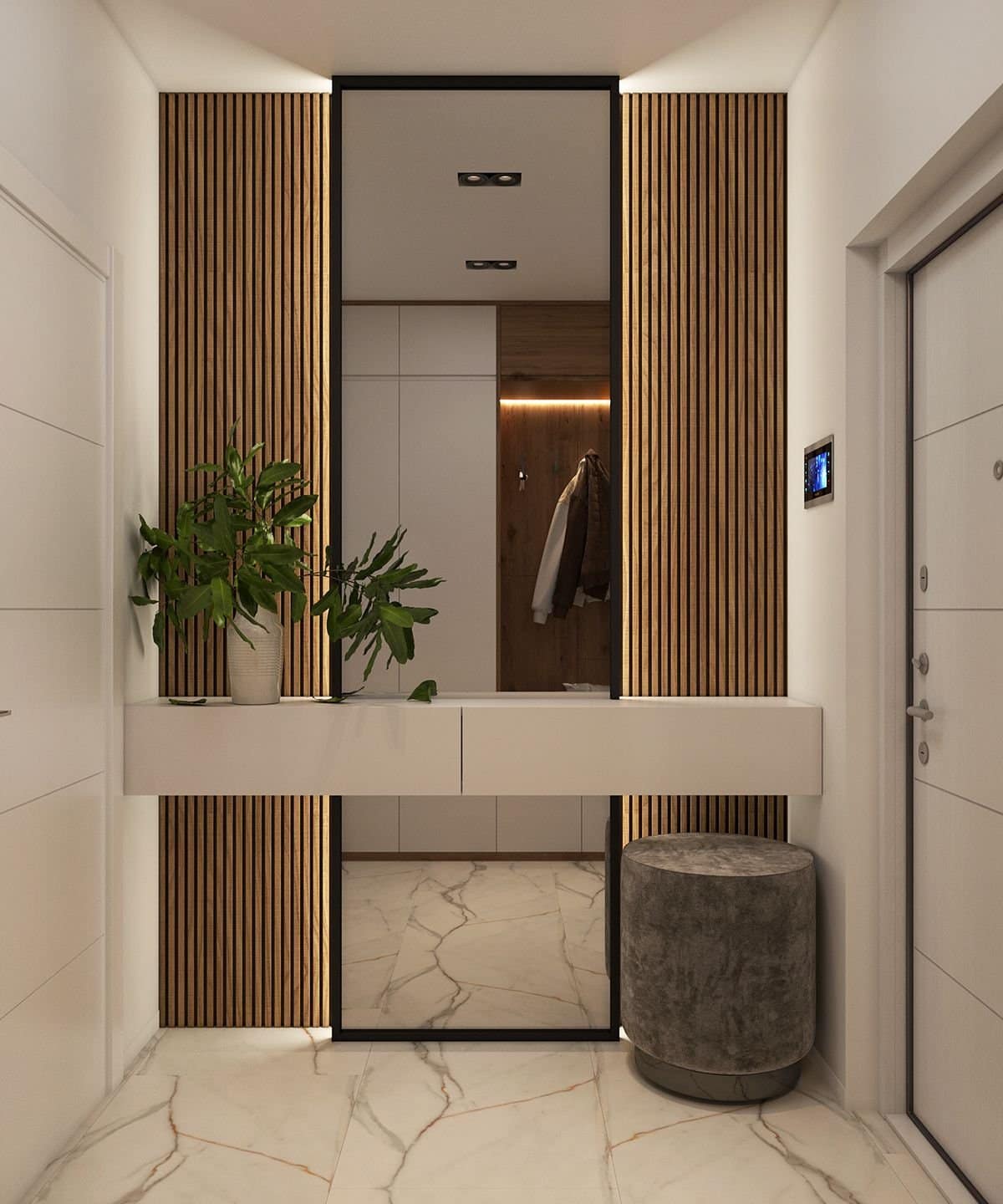 Modern entryway interior design by Olangana Design in Bangalore, showcasing elegant wooden slat wall panels, a large mirror, floating console, and luxurious marble flooring.