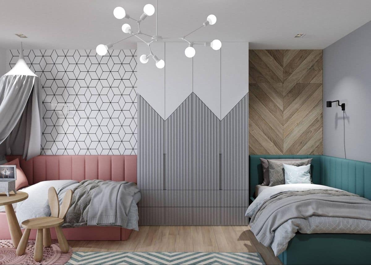 Modern children's bedroom interior design by Olangana in Bangalore, featuring two distinct beds with upholstered headboards, geometric wallpaper, chevron wood paneling, custom wardrobes, and a stylish chandelier.