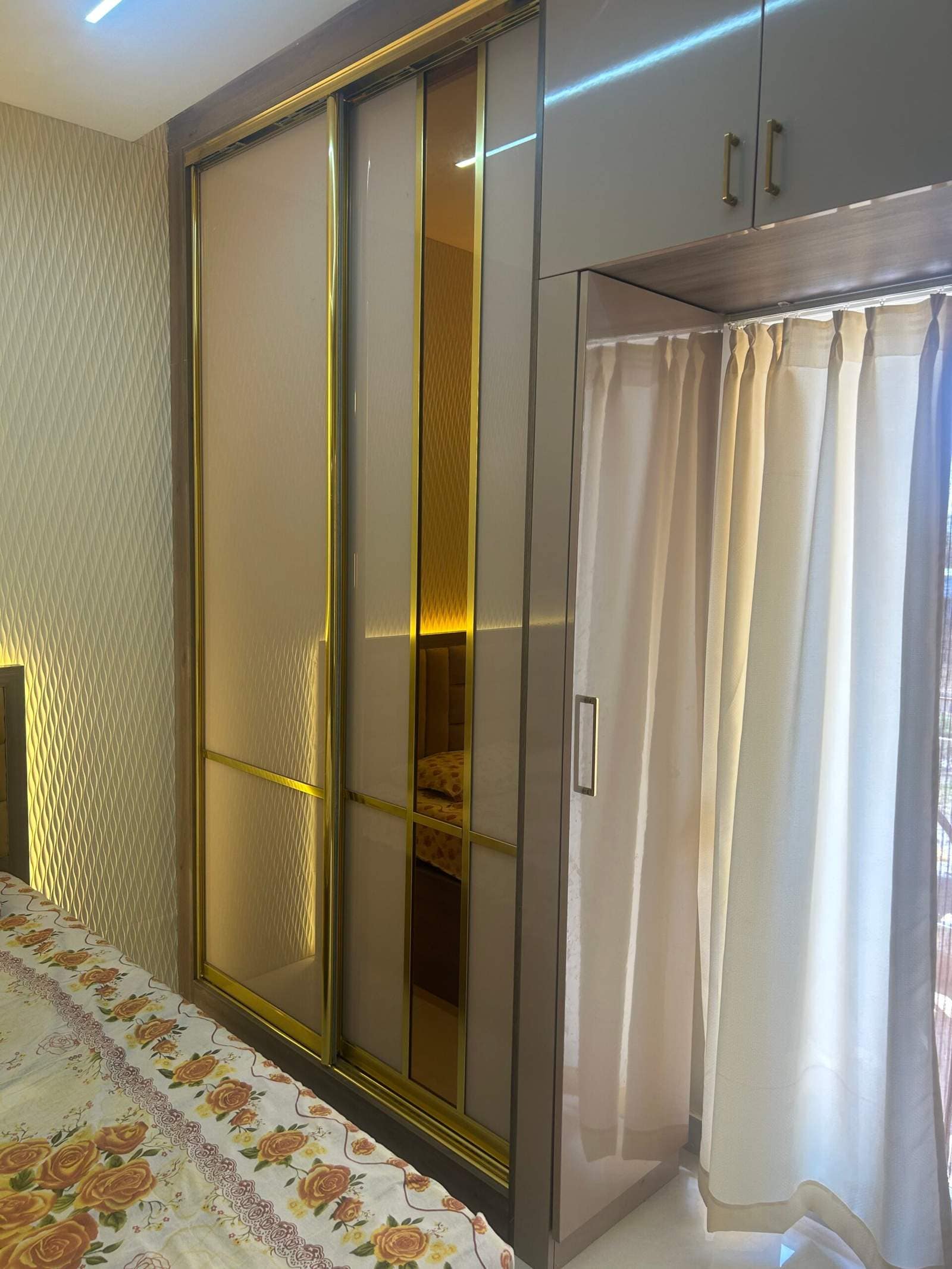 Modern bedroom interior with sliding wardrobe in a Bangalore home by Olangana Design’s.