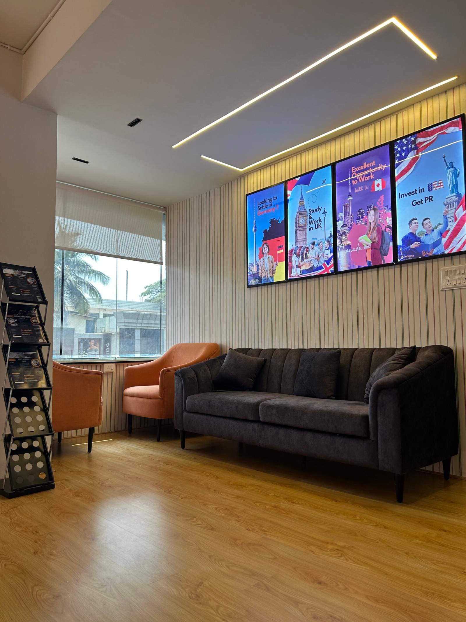 Modern office lounge in Bangalore with two opposite sofas and three framed wall paintings by Olangana Designs