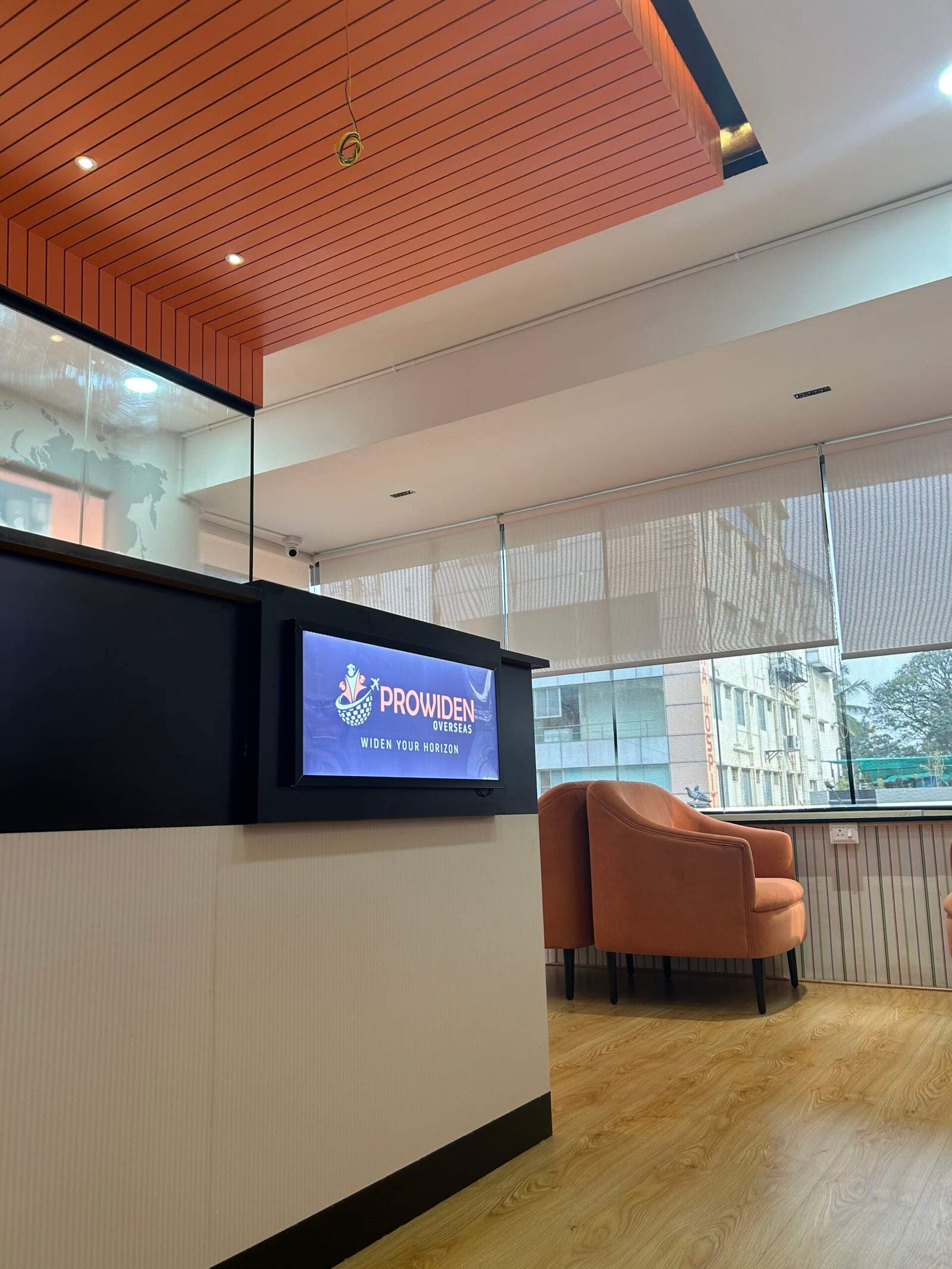 Modern office lounge in Bangalore with opposite sofa seating near window for relaxed discussion area by Olangana Designs