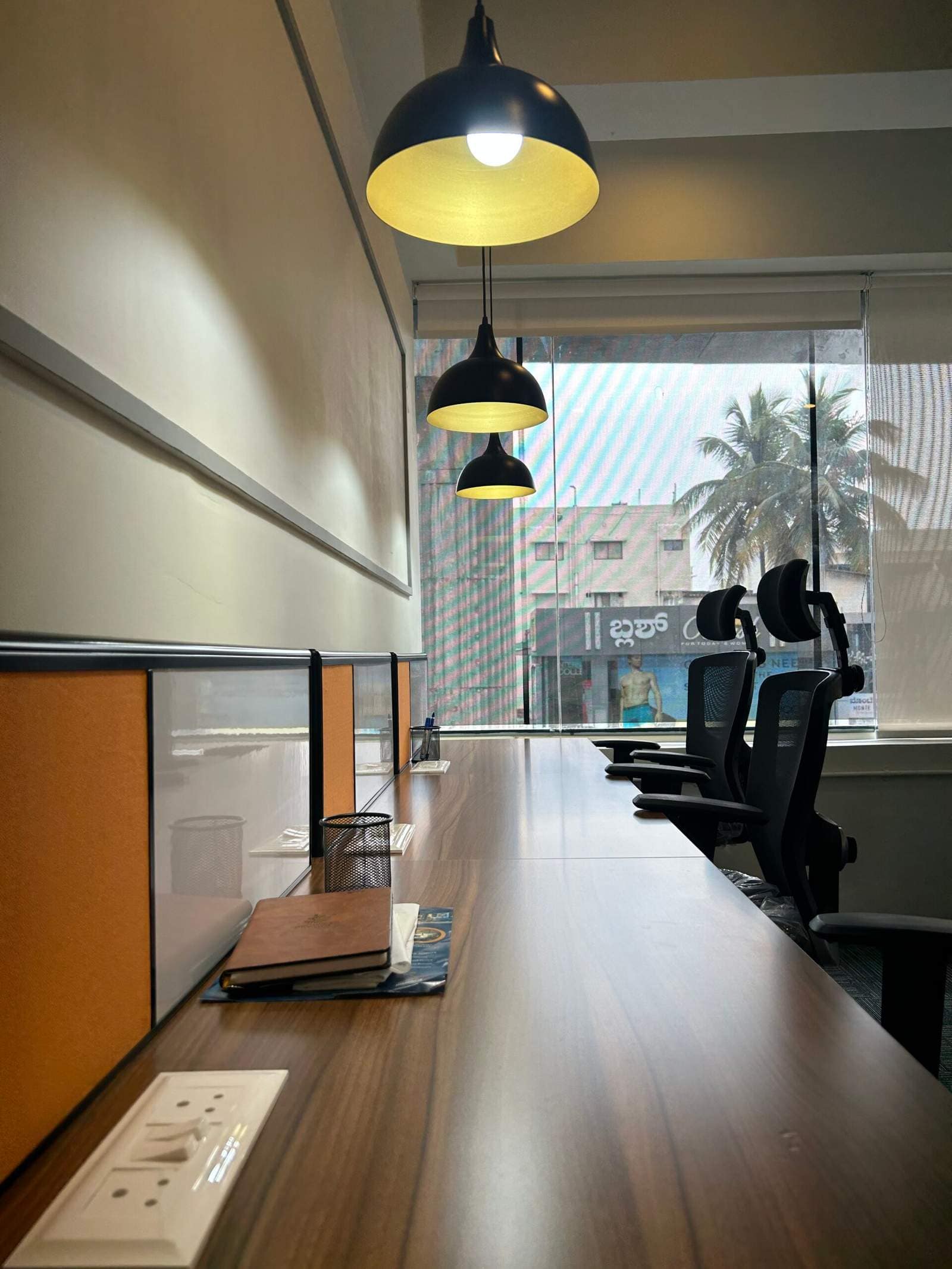 Small corporate office cabin interior with 4 chairs and modern workspace design in Bangalore by Olangana Design