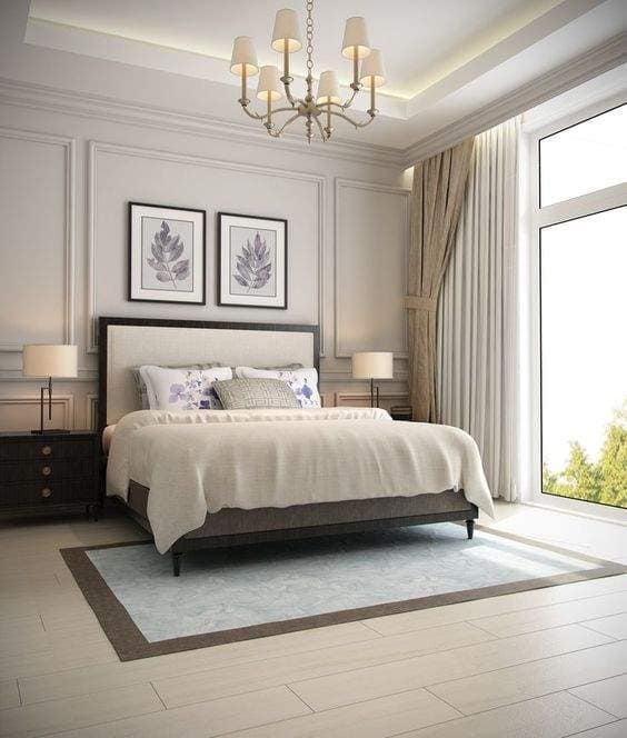 Elegant contemporary bedroom interior design by Olangana Design in Bangalore, featuring a large bed, chandelier, and modern decor elements.