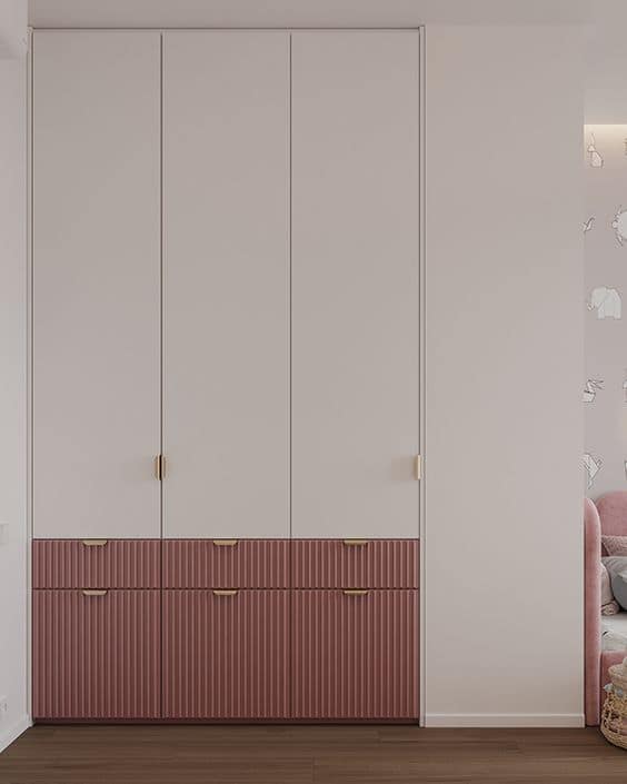Elegant bedroom interior design by Olangana in Bangalore, showcasing custom built-in wardrobes with light neutral upper cabinets and textured dusty rose lower drawers.