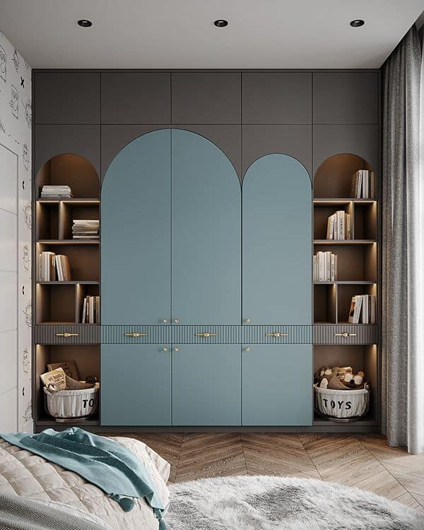 Modern children's bedroom interior featuring custom blue and grey wardrobe with arched doors and integrated shelving, designed by Olangana Design in Bangalore.