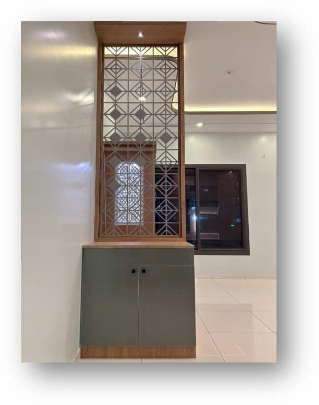 Modern wooden Jali partition with integrated grey storage cabinet by Olangana Design, enhancing residential interior in Bangalore.