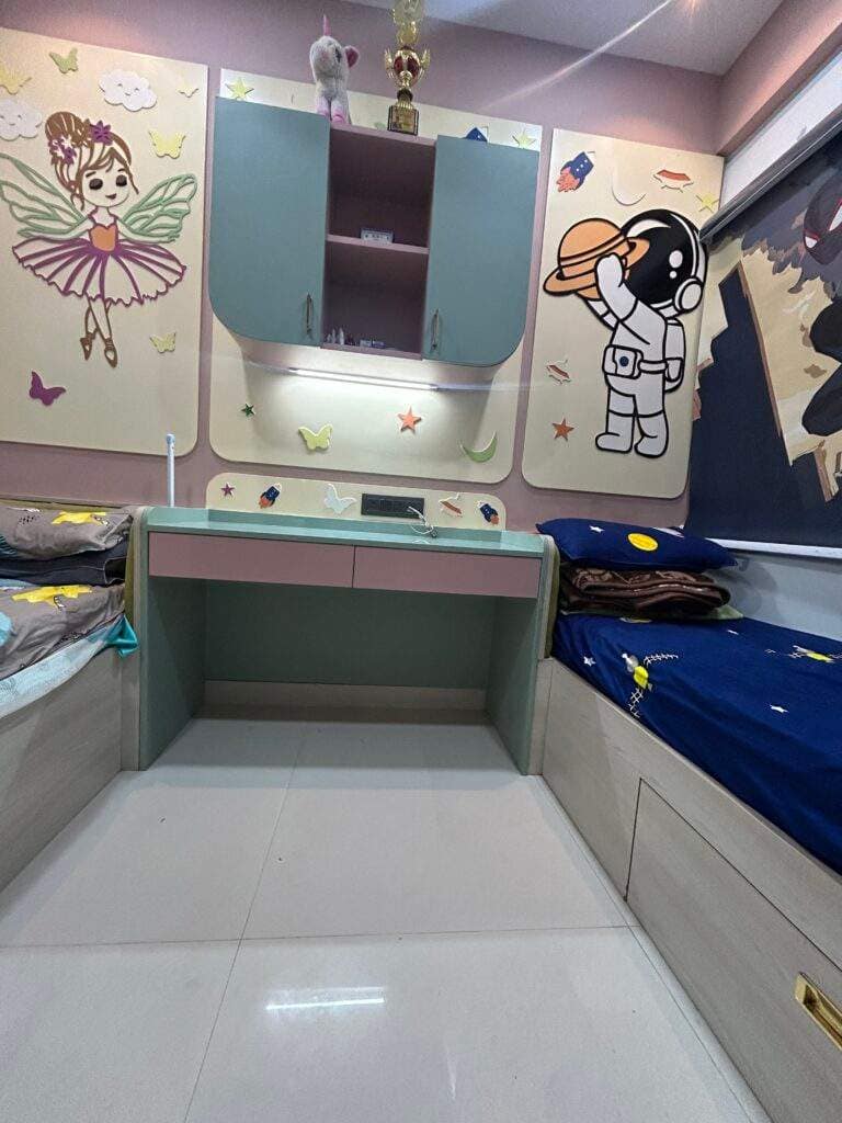 Children’s bedroom for a boy and girl in a Bangalore home with study table, Barbie décor on the girl’s side and astronaut theme on the boy’s side designed by Olangana Design’s.