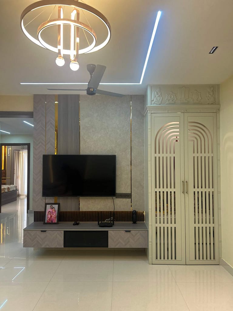 Modern enclosed pooja unit in living hall near TV unit in Bangalore home by Olangana Design’s.