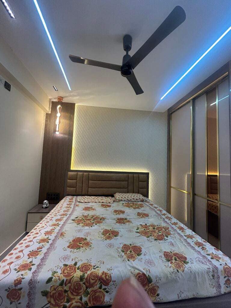 Stylish bedroom area with sliding wardrobe in Bangalore home interior by Olangana Design’s.