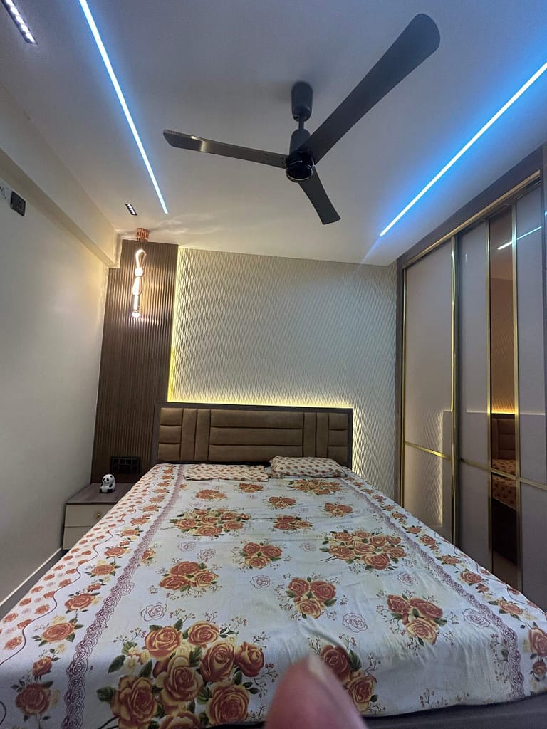Stylish bedroom area with sliding wardrobe in Bangalore home interior by Olangana Design’s.