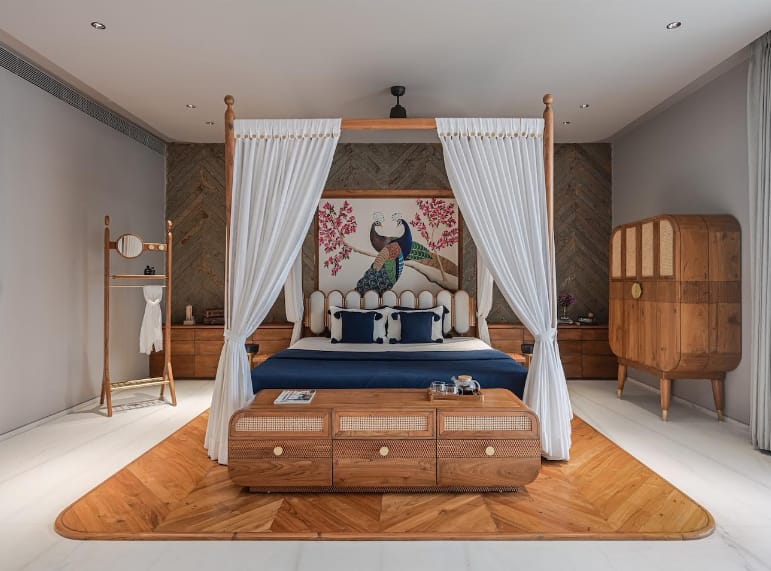 Luxurious master bedroom interior with a four-poster bed, vibrant peacock art headboard, and wooden furniture, expertly designed by Olangana Design in Bangalore.