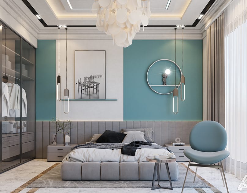 Modern bedroom interior design by Olangana Design in Bangalore featuring a blue accent wall, grey upholstered bed, contemporary pendant lights, and a sleek glass wardrobe.