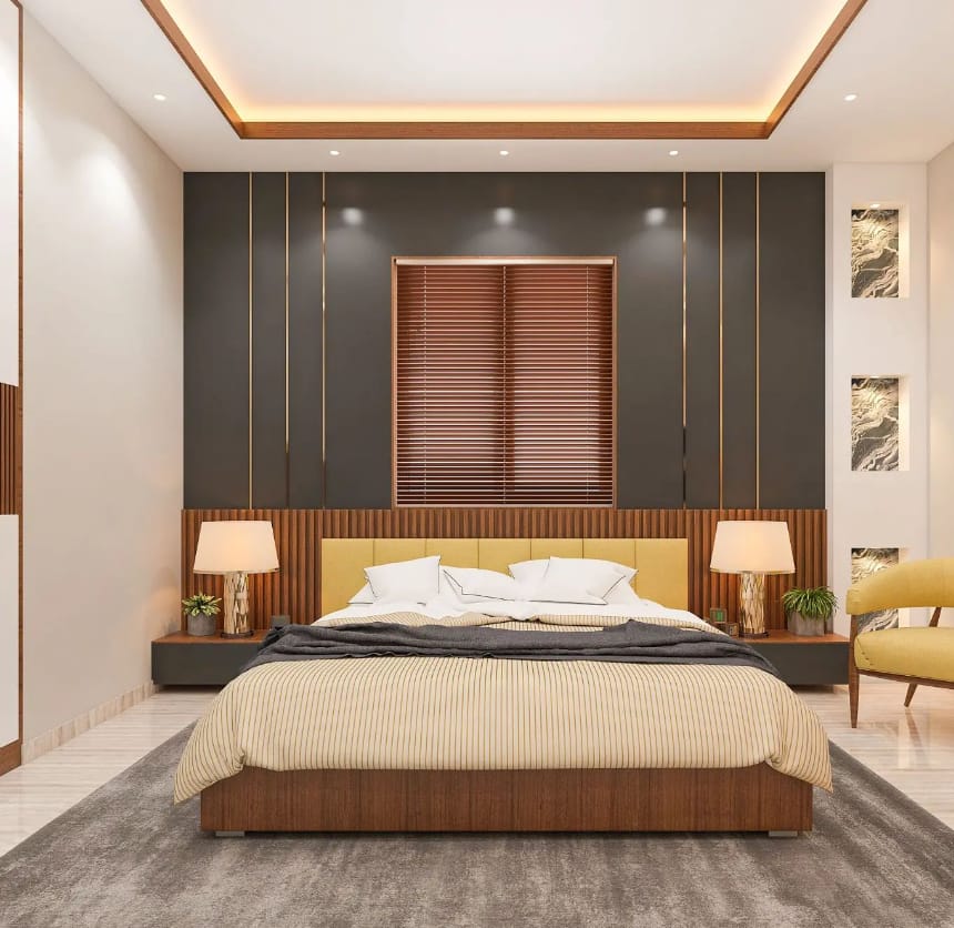 Modern bedroom interior design by Olangana Design in Bangalore featuring a yellow upholstered bed, dark grey accent wall with gold stripes, and wooden blinds.